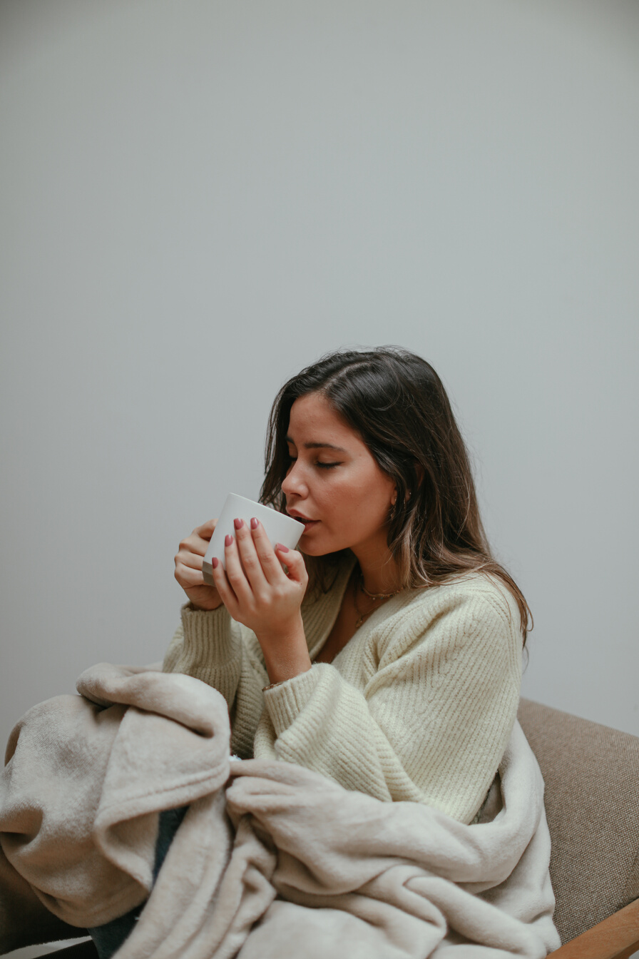 A Woman Sipping Tea From a Cup